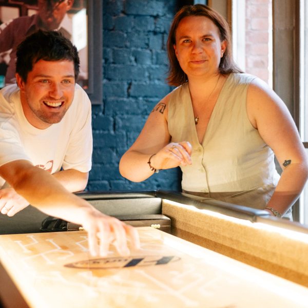 a couple playing shuffleboard on date night